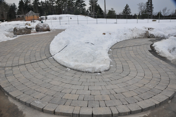Lee Dunning continues work on the paving, and as of today he had begun work on the area outside the activity shelter.