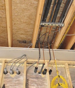 Insulated refrigerant pipes coming from the compressors and headed to the second floor offices.