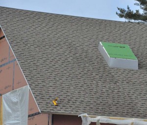 A view of the completed architectural roof shingles with skylight opening (the skylights are yet to be installed).